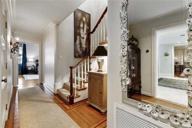 105 Mulberry Dr, Metairie, LA 70005 - entryway with stairway, light wood-style floors, ornamental molding, and baseboards