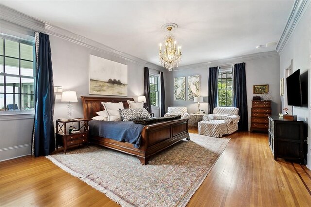 105 Mulberry Dr, Metairie, LA 70005 - bedroom with a chandelier, wood finished floors, crown molding, and baseboards