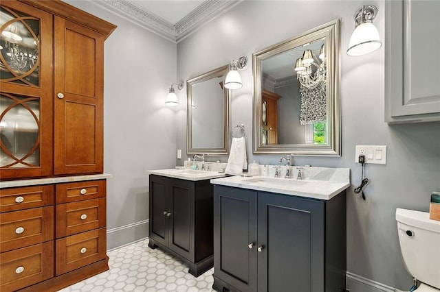 105 Mulberry Dr, Metairie, LA 70005 - full bath featuring two vanities, toilet, ornamental molding, baseboards, and tile patterned floors