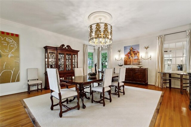 105 Mulberry Dr, Metairie, LA 70005 - dining space featuring a chandelier, crown molding, wood finished floors, and baseboards