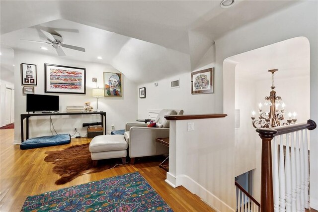 105 Mulberry Dr, Metairie, LA 70005 - living area featuring vaulted ceiling, ceiling fan, wood finished floors, a chandelier, and baseboards