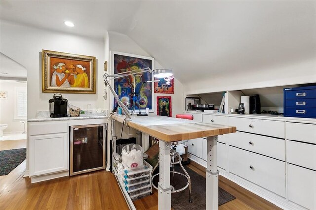 105 Mulberry Dr, Metairie, LA 70005 - office space featuring beverage cooler, wood finished floors, wet bar, vaulted ceiling, and recessed lighting
