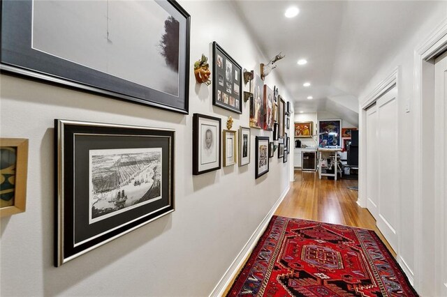 105 Mulberry Dr, Metairie, LA 70005 - hall with wood finished floors, vaulted ceiling, recessed lighting, and baseboards