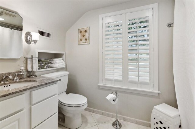 105 Mulberry Dr, Metairie, LA 70005 - bathroom featuring toilet, vanity, tile patterned floors, lofted ceiling, and baseboards