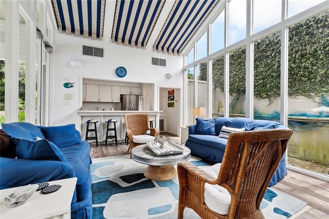 105 Mulberry Dr, Metairie, LA 70005 - sunroom / solarium with wood finished floors and a towering ceiling