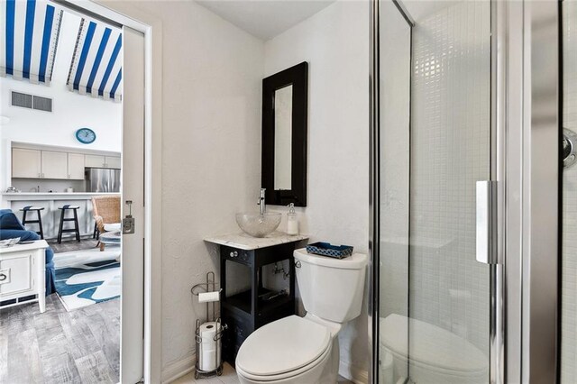 105 Mulberry Dr, Metairie, LA 70005 - bathroom featuring toilet, a shower stall, and vanity