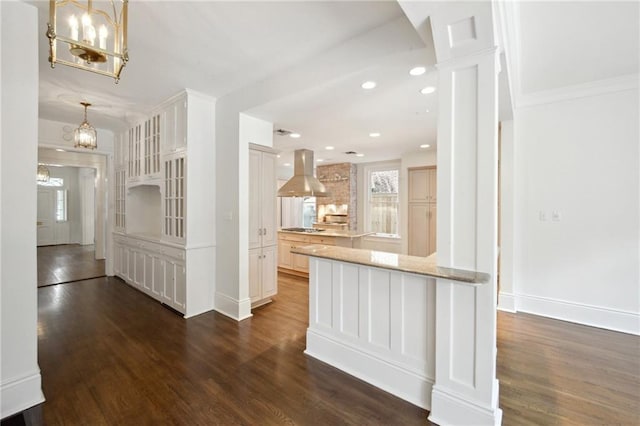 1923 State St, New Orleans, LA 70118 - kitchen with island range hood, a chandelier, dark wood-style flooring, baseboards, and recessed lighting