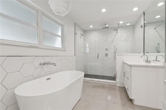 3705 James Dr, Metairie, LA 70003 - bathroom featuring tile walls, a stall shower, vanity, recessed lighting, and a freestanding bath