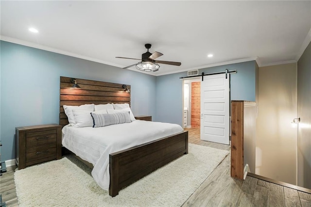 5844 Fleur De Lis Dr, New Orleans, LA 70124 - bedroom with light wood finished floors, a barn door, ornamental molding, recessed lighting, and baseboards