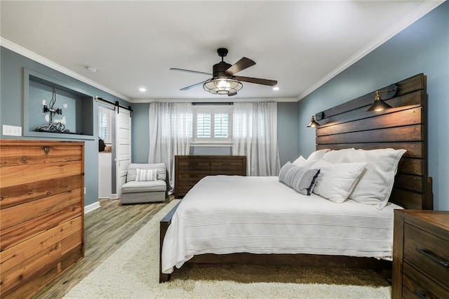 5844 Fleur De Lis Dr, New Orleans, LA 70124 - bedroom with a barn door, ornamental molding, wood finished floors, recessed lighting, and a ceiling fan