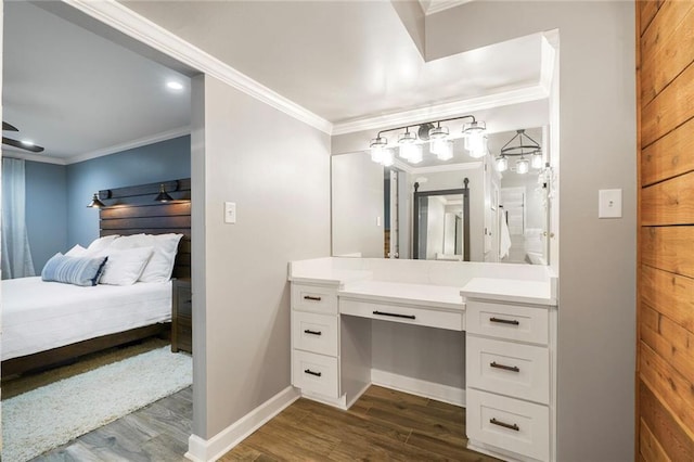 5844 Fleur De Lis Dr, New Orleans, LA 70124 - bathroom with vanity, wood finished floors, crown molding, connected bathroom, and baseboards