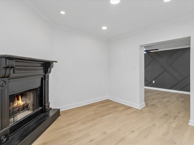 1705 Haring Rd, Metairie, LA 70001 - unfurnished living room featuring crown molding, light wood-style flooring, baseboards, a lit fireplace, and recessed lighting
