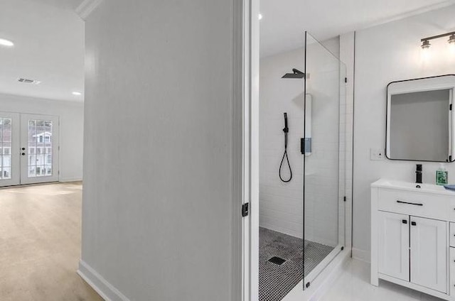 1705 Haring Rd, Metairie, LA 70001 - bathroom featuring a shower stall, vanity, baseboards, french doors, and recessed lighting