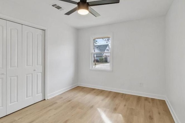 1705 Haring Rd, Metairie, LA 70001 - unfurnished bedroom featuring light wood-type flooring, a closet, baseboards, and ceiling fan