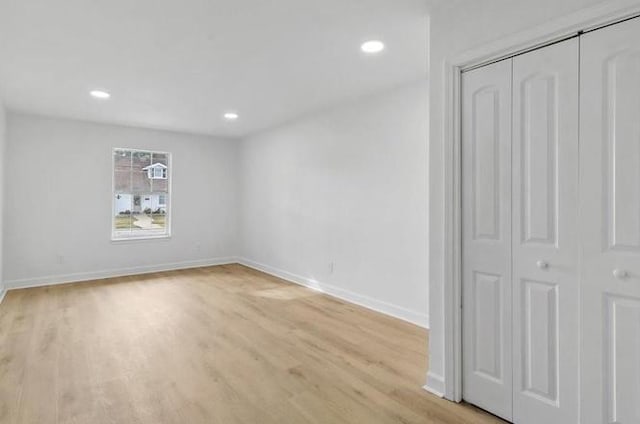 1705 Haring Rd, Metairie, LA 70001 - unfurnished bedroom featuring light wood-style floors, baseboards, a closet, and recessed lighting