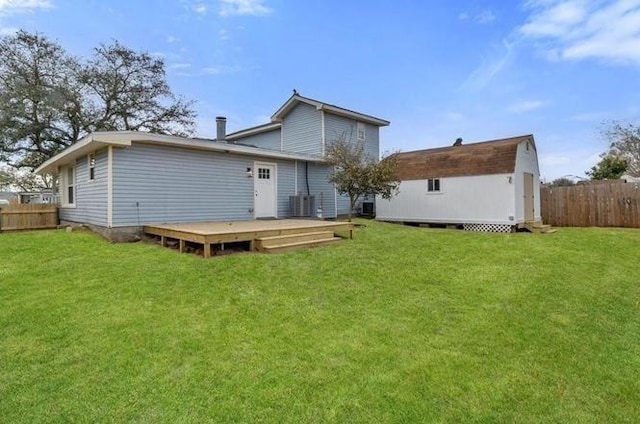 1705 Haring Rd, Metairie, LA 70001 - back of house with a wooden deck, an outbuilding, and central air condition unit