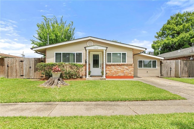 2305 Generes Dr, Harahan, LA 70123 - view of front facade featuring brick siding, driveway, and a gate