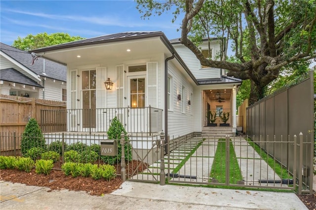 1015 Cadiz St, New Orleans, LA 70115 - view of front of house featuring covered porch, a fenced front yard, a gate, and a ceiling fan
