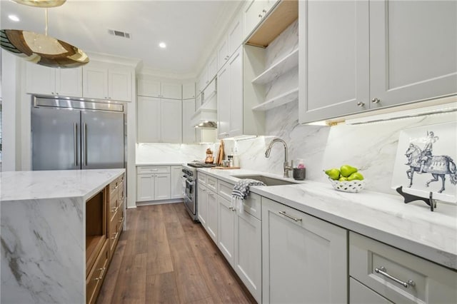 1015 Cadiz St, New Orleans, LA 70115 - kitchen featuring appliances with stainless steel finishes, a sink, tasteful backsplash, dark wood finished floors, and open shelves