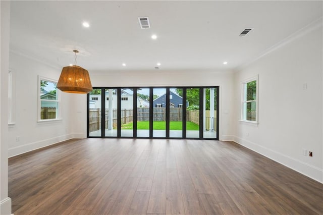 1015 Cadiz St, New Orleans, LA 70115 - unfurnished living room with ornamental molding, healthy amount of natural light, wood finished floors, baseboards, and recessed lighting