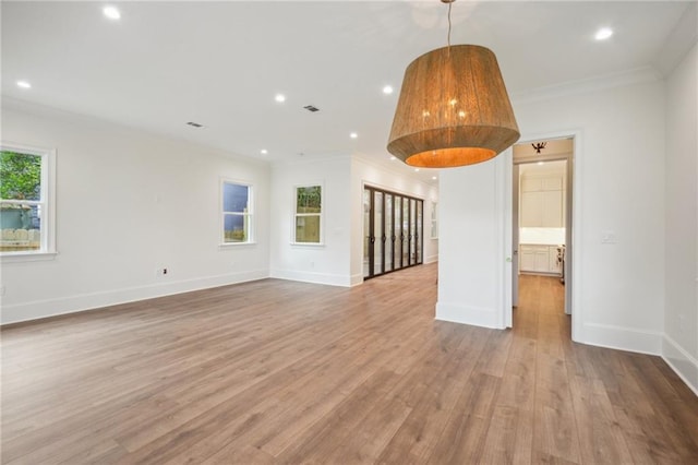 1015 Cadiz St, New Orleans, LA 70115 - spare room with wood finished floors, crown molding, recessed lighting, and baseboards