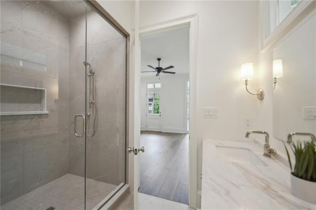 1015 Cadiz St, New Orleans, LA 70115 - full bathroom with a shower stall, wood finished floors, vanity, and a ceiling fan