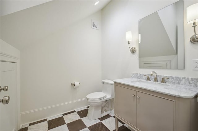 1015 Cadiz St, New Orleans, LA 70115 - bathroom featuring vaulted ceiling, vanity, toilet, and baseboards