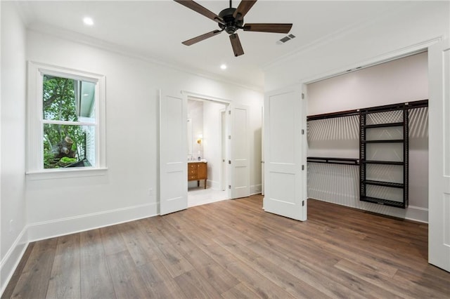 1015 Cadiz St, New Orleans, LA 70115 - unfurnished bedroom with ornamental molding, wood finished floors, baseboards, recessed lighting, and ensuite bath