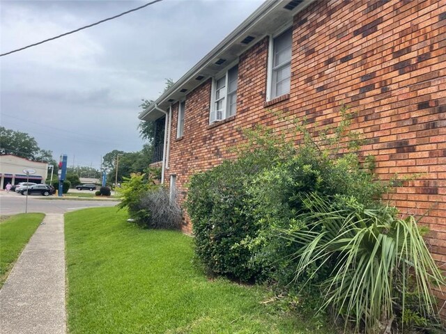 3218 Gentilly Blvd, New Orleans, LA 70122 - view of property exterior with a yard and brick siding