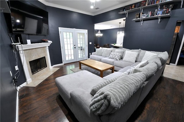 1613 Live Oak St, Slidell, LA 70460 - living room featuring wood finished floors, a premium fireplace, ornamental molding, and french doors