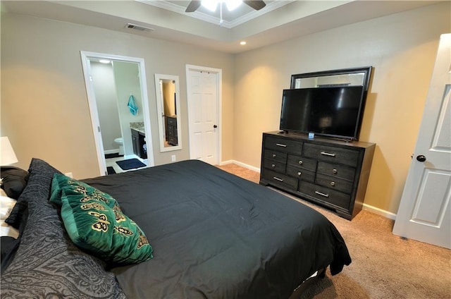 1613 Live Oak St, Slidell, LA 70460 - bedroom with crown molding, light carpet, a raised ceiling, connected bathroom, and ceiling fan