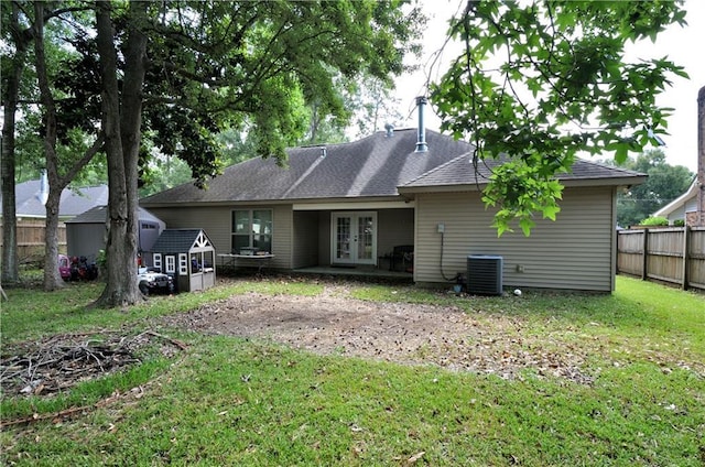 1613 Live Oak St, Slidell, LA 70460 - rear view of property with french doors, a shed, a fire pit, and roof with shingles