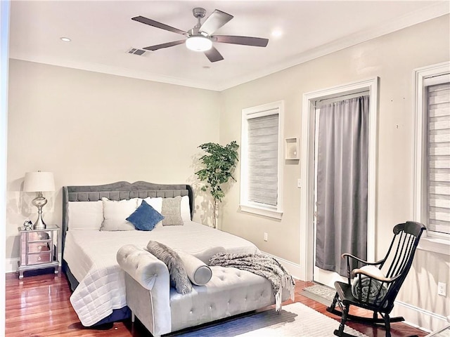 714 Third St, New Orleans, LA 70130 - bedroom with wood finished floors, baseboards, crown molding, and a ceiling fan