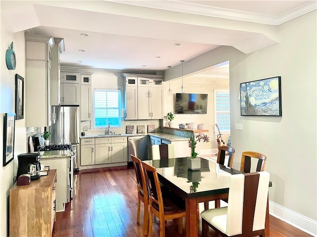 714 Third St, New Orleans, LA 70130 - dining area with healthy amount of natural light, dark wood finished floors, ornamental molding, baseboards, and recessed lighting