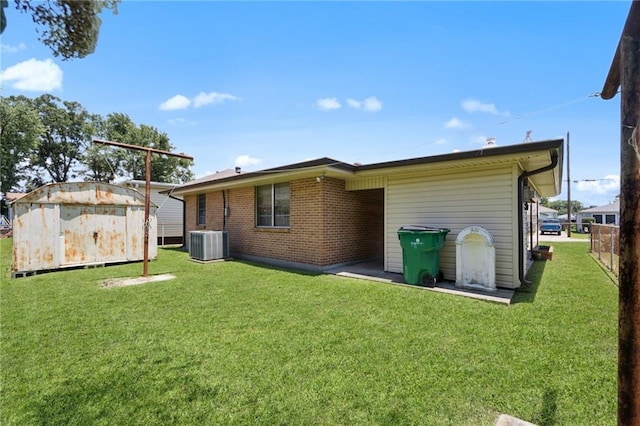 564 Saint Ann St, Marrero, LA 70072 - back of house featuring central AC and brick siding