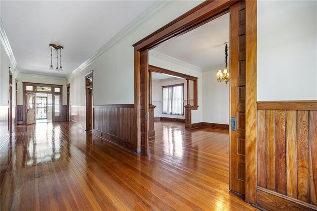 215 N 6th St, Ponchatoula, LA 70454 - hallway featuring a chandelier, hardwood / wood-style flooring, a wainscoted wall, crown molding, and wood walls