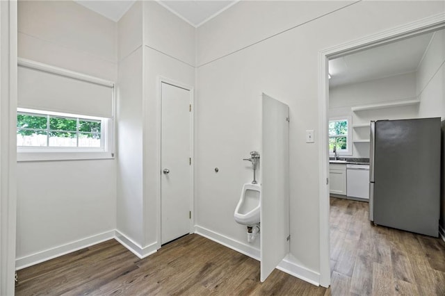 215 N 6th St, Ponchatoula, LA 70454 - corridor with wood finished floors, attic access, a sink, and baseboards