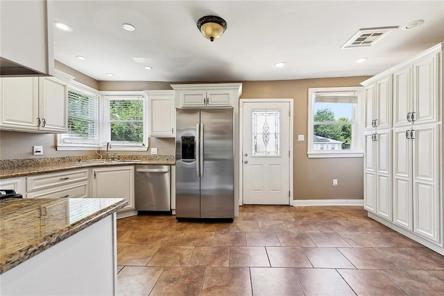 4959 Elysian Fields Ave, New Orleans, LA 70122 - kitchen featuring appliances with stainless steel finishes, a sink, plenty of natural light, baseboards, and recessed lighting