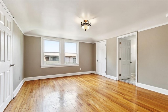 4959 Elysian Fields Ave, New Orleans, LA 70122 - unfurnished bedroom featuring light wood-type flooring, baseboards, and crown molding