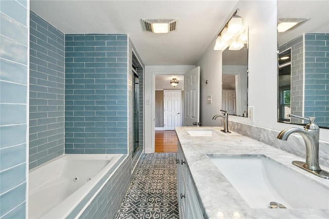 4959 Elysian Fields Ave, New Orleans, LA 70122 - bathroom with a whirlpool tub, a shower, double vanity, and tile patterned flooring