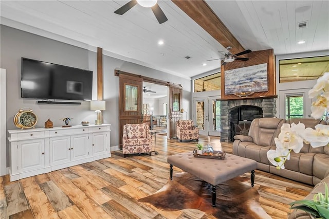 18064 Faller Rd, Tickfaw, LA 70466 - living room featuring a ceiling fan, light wood-style floors, a stone fireplace, baseboards, and recessed lighting