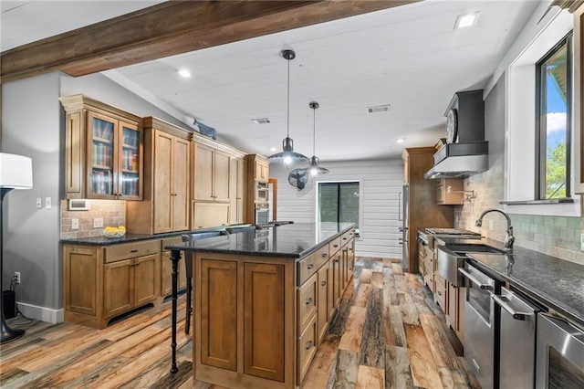 18064 Faller Rd, Tickfaw, LA 70466 - kitchen with dark wood-style floors, healthy amount of natural light, brown cabinets, decorative backsplash, and recessed lighting