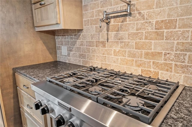 18064 Faller Rd, Tickfaw, LA 70466 - kitchen with range, tasteful backsplash, and dark stone counters