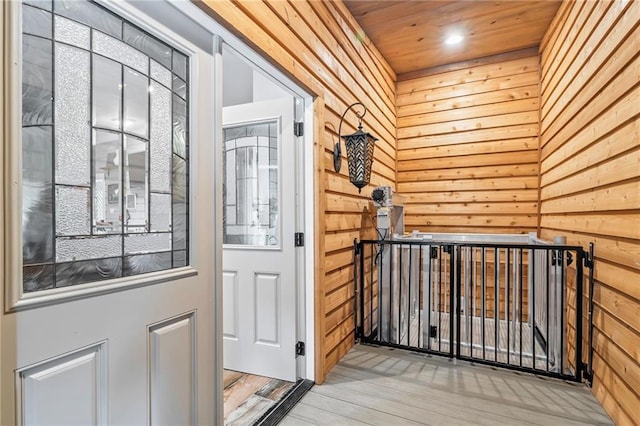 18064 Faller Rd, Tickfaw, LA 70466 - doorway to outside with wood walls and wood finished floors