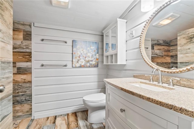 18064 Faller Rd, Tickfaw, LA 70466 - full bath featuring vanity, tiled shower, wood finished floors, and toilet