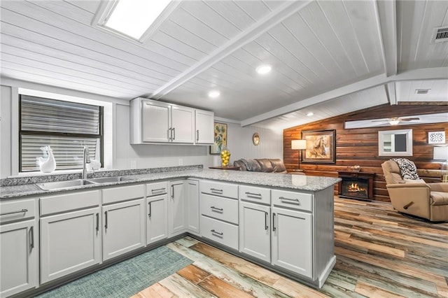 18064 Faller Rd, Tickfaw, LA 70466 - kitchen with a sink, a peninsula, open floor plan, light wood-style floors, and wooden ceiling