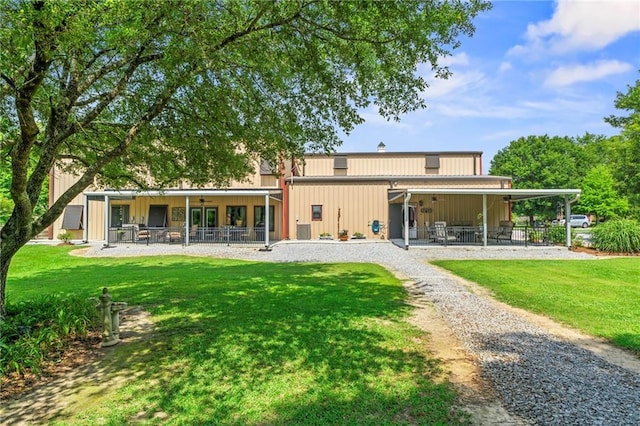 18064 Faller Rd, Tickfaw, LA 70466 - back of property featuring a patio area, a ceiling fan, a yard, and board and batten siding