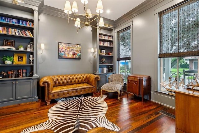1026 Valence St, New Orleans, LA 70115 - sitting room featuring crown molding, a chandelier, wood finished floors, and built in features