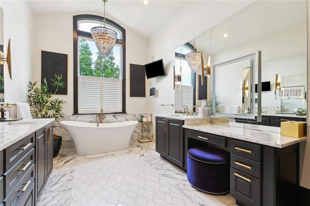 1026 Valence St, New Orleans, LA 70115 - bathroom featuring healthy amount of natural light, lofted ceiling, a chandelier, a freestanding bath, and vanity