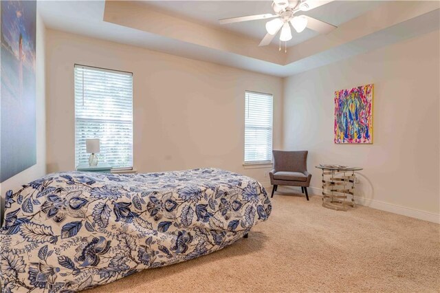 52 Hickory Dr, Covington, LA 70433 - bedroom featuring carpet flooring, a ceiling fan, baseboards, and a tray ceiling